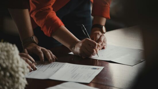 People signing documents for a wedding