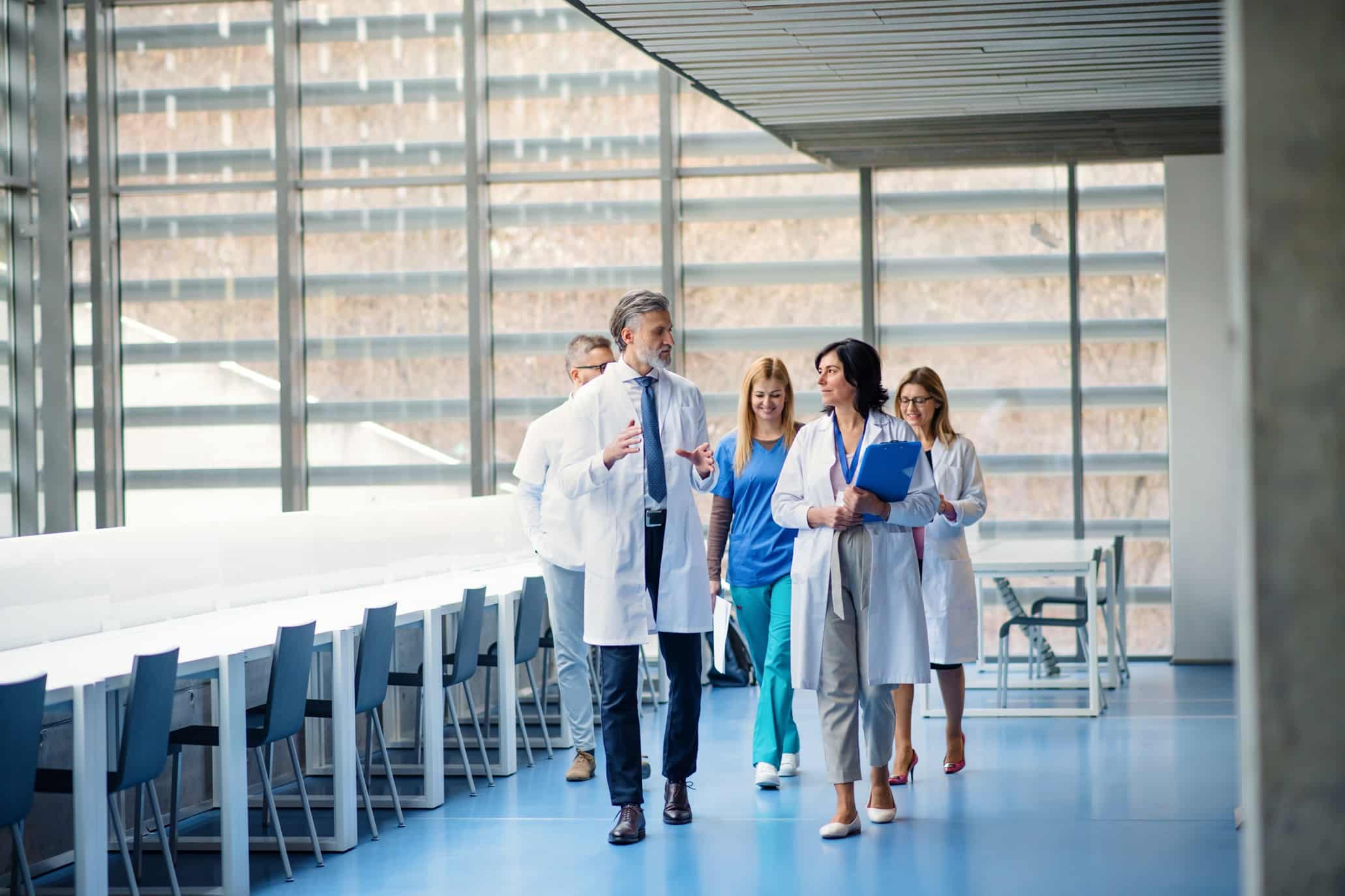 The Physician's Guide to Long-Term Disability Insurance Claims 4 Group of physicians discussing long-term disability insurance and medical practice coverage